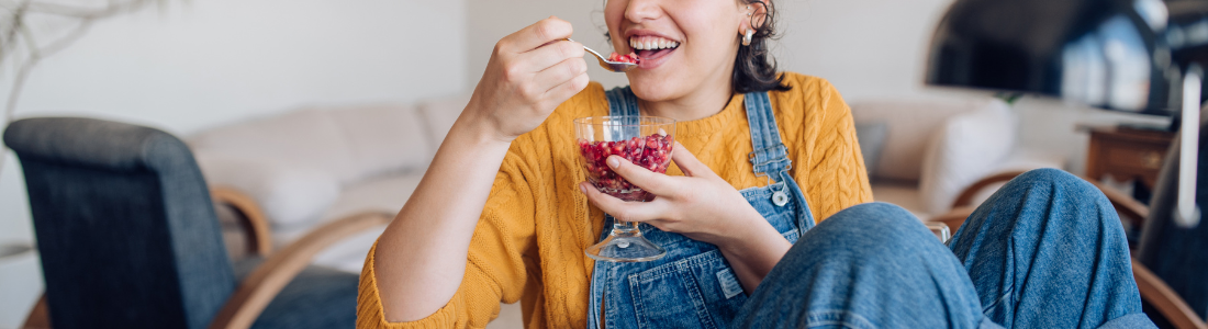 woman sitting at desk eating a snack