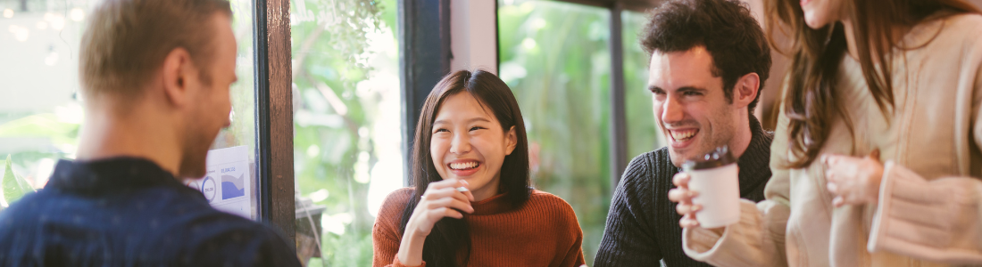 group of four people smiling 